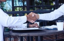 two men shaking hands after interview