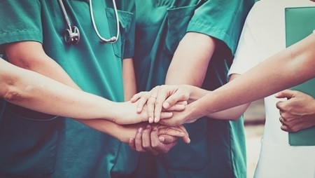 How to become a doctor concept with doctors holding hands