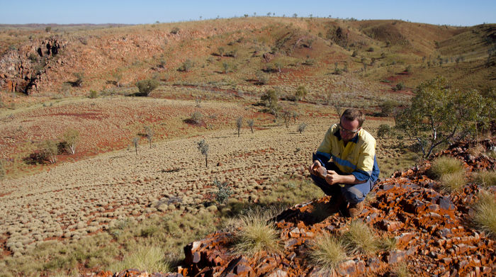 Geoscientist examining rock