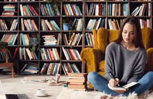 Young woman writing at library