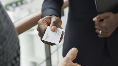 Closeup of businessman giving his business card to another businessman