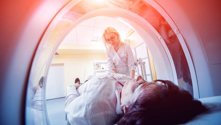 Female doctor preparing a patient for a CT scan
