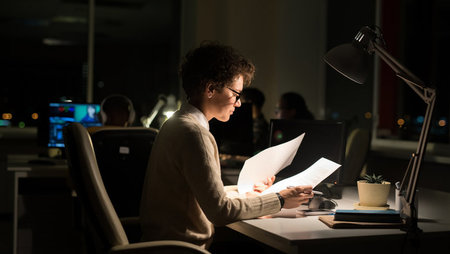 Woman working in the office at night-time