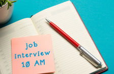 Job interview reminder written on sticky note