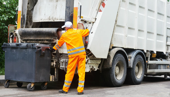 A waste disposal operator collecting rubbish