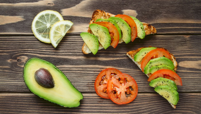 Sliced avocado and tomato on toast