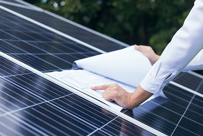 Solar project developer working on a solar PV panel