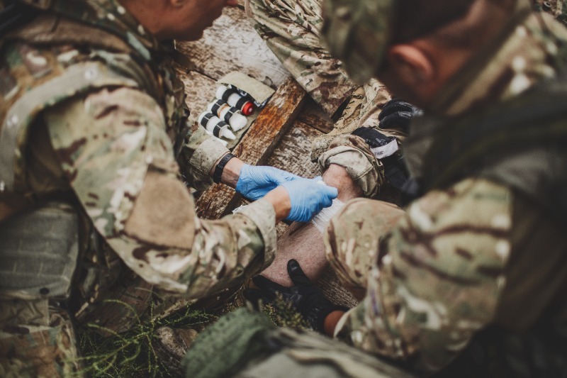 A couple of army medics treating an injured soldier