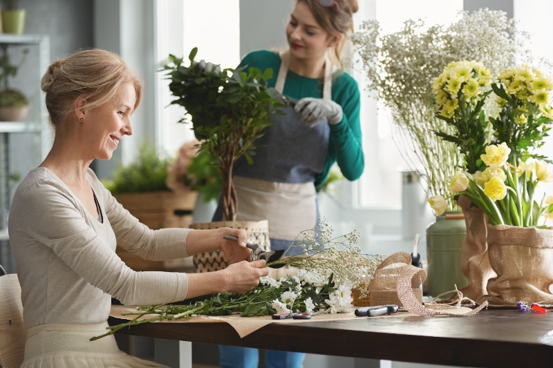 Floral designers assembling flower bouquets 