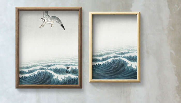 Two wooden frames hanging on a grey wall